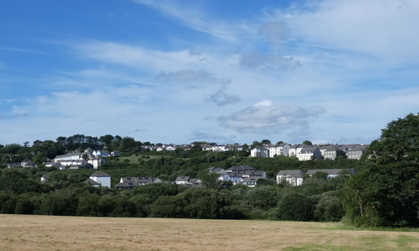 Views over a hayfield to Gloweth